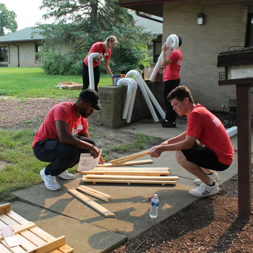 A Group of People Building with Wood